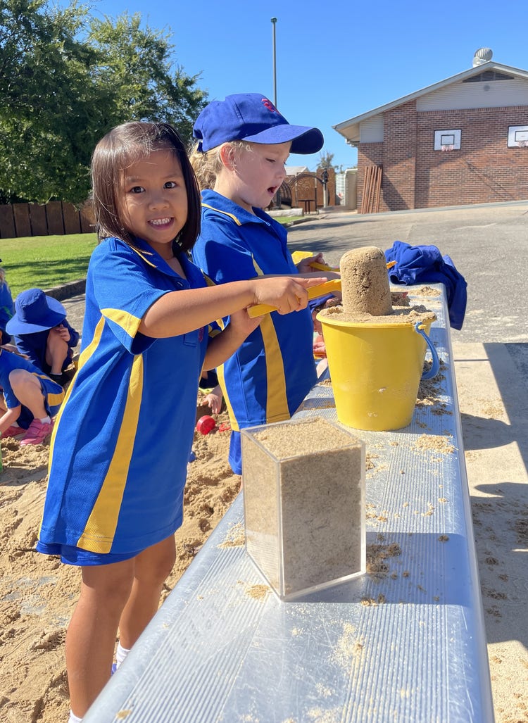 Students playing in the sandpit.