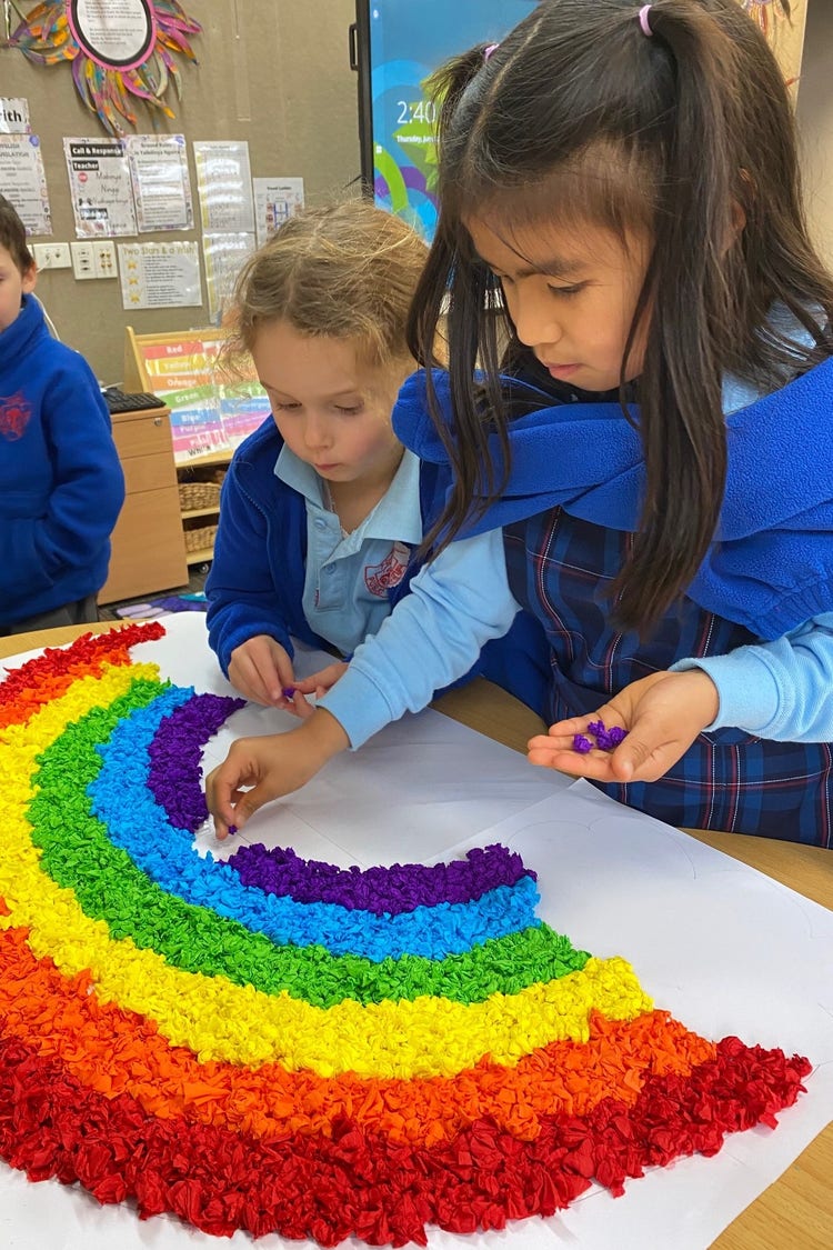 Students creating a rainbow.