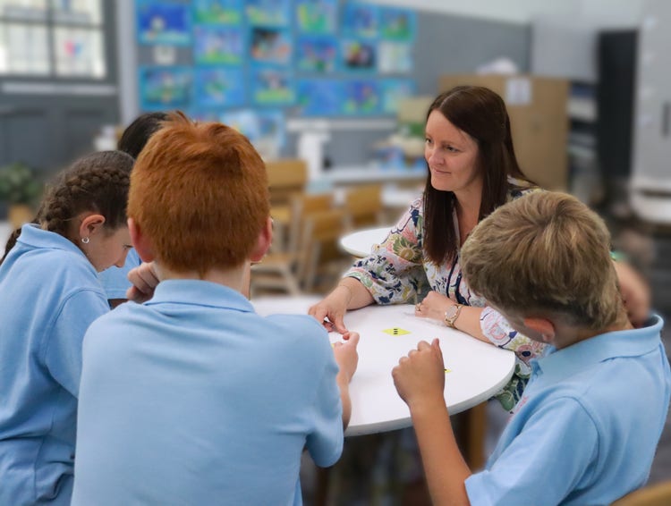 Principal sitting with students.