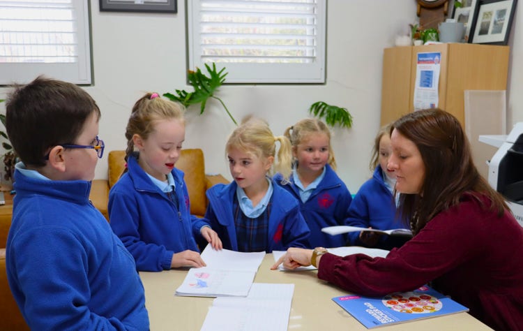 Students showing our Principal their work.