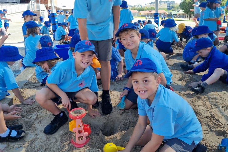 Students playing in the sandpit.