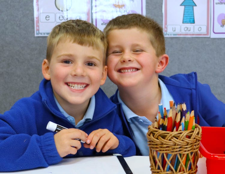 Students smiling whilst engaging in learning.