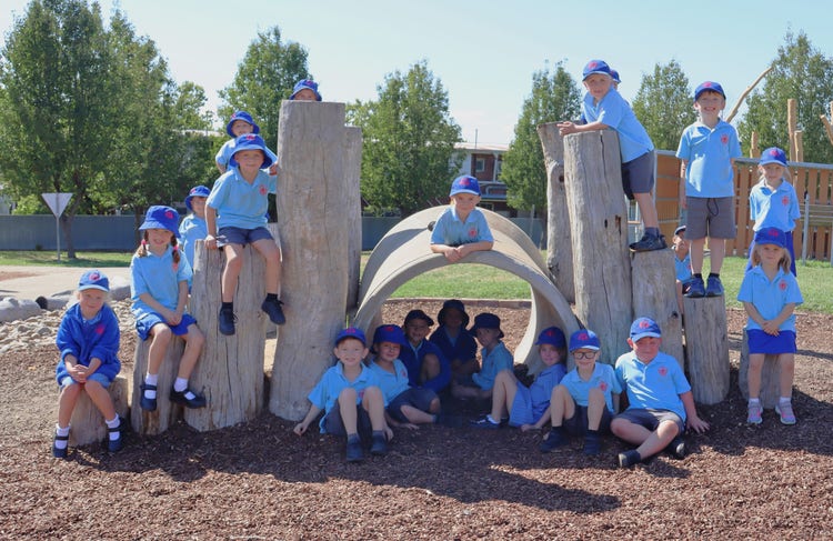 Students sitting in our playground.