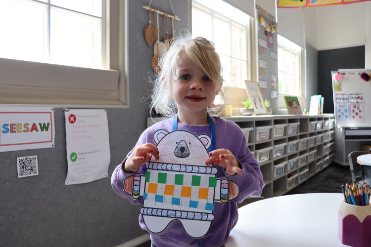 Student holding their artwork.